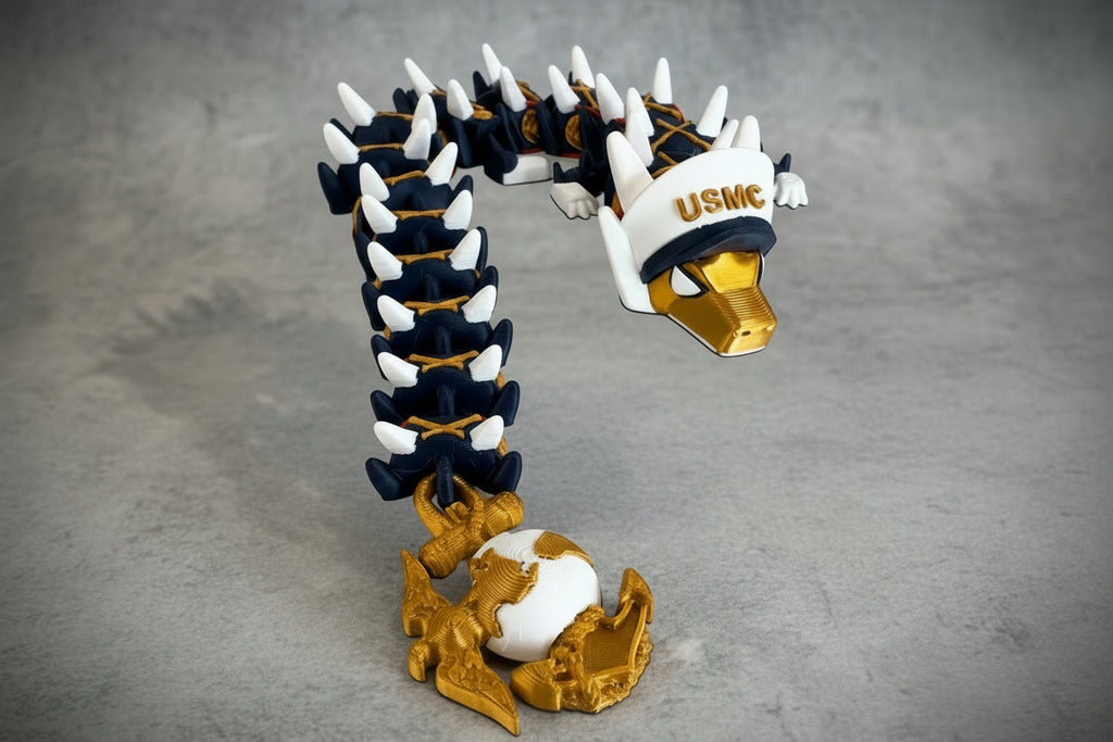 Crafted For Courage USMC dragon toy with gold accents, white USMC hat, and globe base.