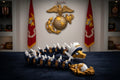 Crafted For Courage USMC dragon toy with gold accents, navy blue segments, white spikes, and an anchor emblem.