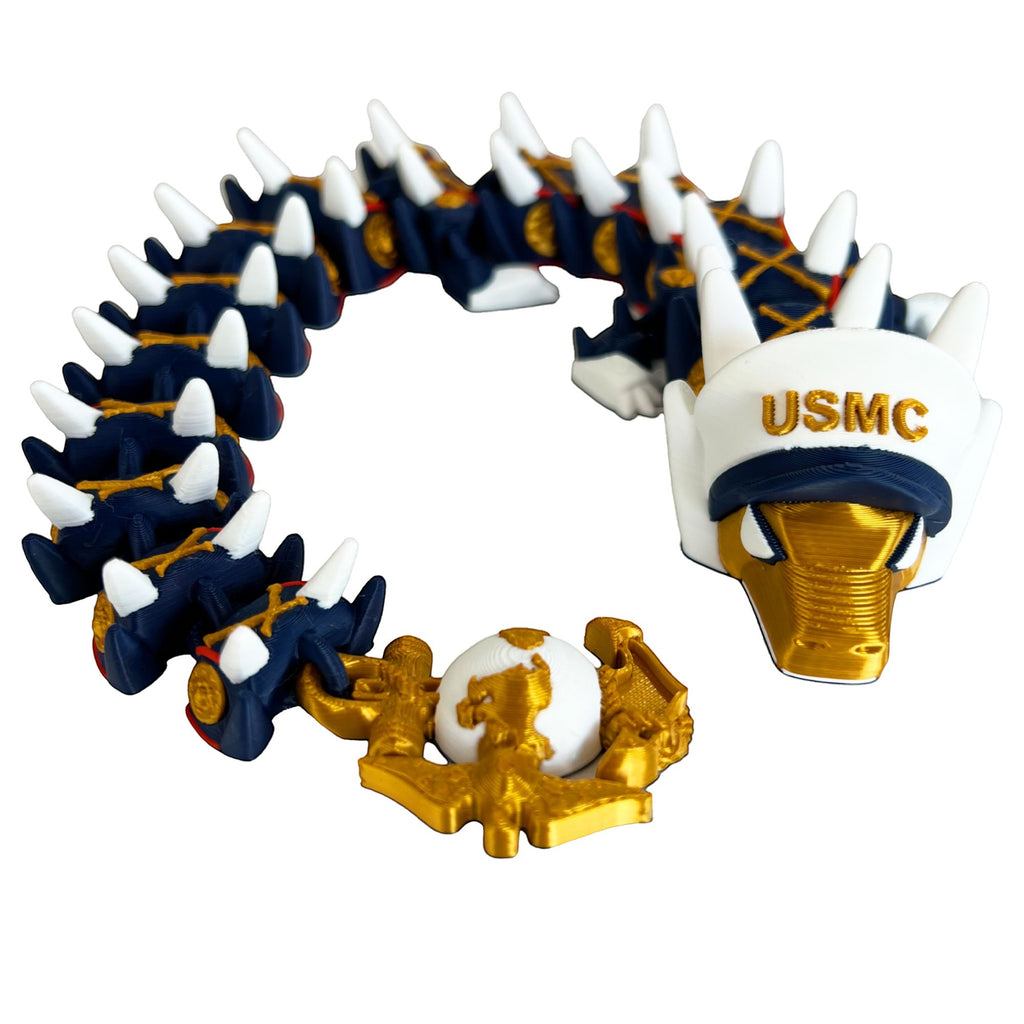 Crafted For Courage USMC dragon toy with USMC hat and globe emblem. Dark blue, white, and gold.